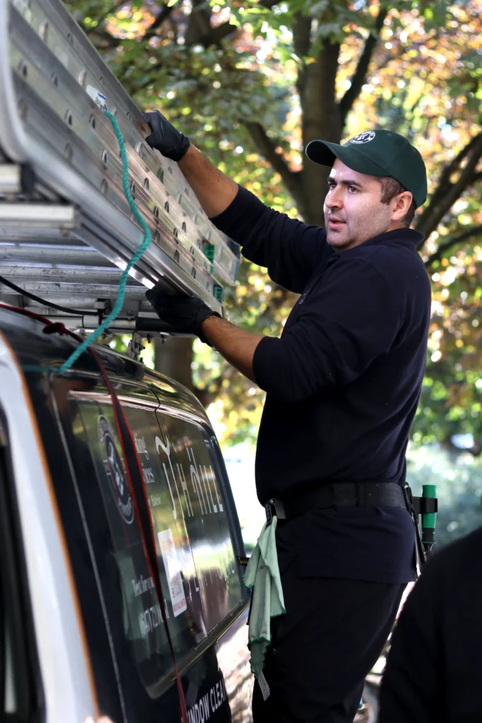 Professional window cleaning technician preparing safety ladders for a residential service in North York, Toronto.